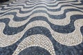 Tile brick floor in Lisbon, Portugal. Traditional old type mosaic on the sidewalk or pavement in the city Royalty Free Stock Photo