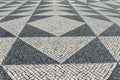 Tile brick floor in Lisbon, Portugal. Traditional old type mosaic on the sidewalk or pavement in the city Royalty Free Stock Photo