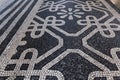 Tile brick floor in Lisbon, Portugal. Traditional old type mosaic on the sidewalk or pavement in the city Royalty Free Stock Photo