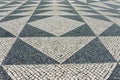 Tile brick floor in Lisbon, Portugal. Traditional old type mosaic on the sidewalk Royalty Free Stock Photo