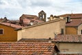 Tile, chimneys on house roofs and church bell tower in the town of Magliano in Toscana Royalty Free Stock Photo