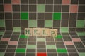 Tile with green help text on a blocked background Royalty Free Stock Photo