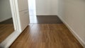Tile in the hallway in a new apartment. Long modern hallway with large and white wardrobe Royalty Free Stock Photo