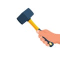 Tile hammer in the hands of a tile master. Hammer with rubberized yellow handle.