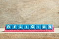Tile letter on rack in word religion on wood background Royalty Free Stock Photo