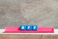 Tile letter on rack in word BFF Abbreviation of best friend forever on wood background