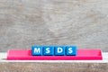 Tile letter on rack in word MSDS Abbreviation of material safety data sheet on wood background