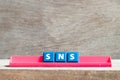 Tile letter on rack in word SNS abbreviation of Social Networking Site or sorry not sorry on wood background
