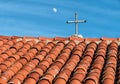 Tile roof and rustic cross on historic church