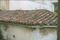 A red Tile roof with a water drain