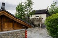 Tile-roofed timberwork buildings with ancient temple in distance