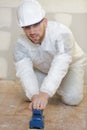 Tile setter preparing floor