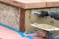 Tile Worker Applying Cement with Trowel at Pool Construction Site Royalty Free Stock Photo