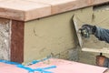 Tile Worker Applying Cement with Trowel at Pool Construction Site Royalty Free Stock Photo