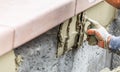 Tile Worker Applying Cement with Trowel at Pool Construction Site Royalty Free Stock Photo