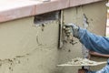 Tile Worker Applying Cement with Trowel at Pool Construction Site Royalty Free Stock Photo