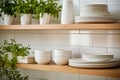 Tiled background and shelves with dishes. Different tableware backdrop. Dishes in cupboard in kitchen. Kitchenware. Kitchen