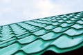 Tiled green roof against blue sky. Concept of building a new house or rooftops Royalty Free Stock Photo