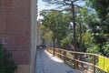 Tiled Outdoor Walking Path along a Fortress Wall and Trees around it Royalty Free Stock Photo