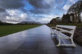 Tiled pathway and metal benches taken in Killarney National Park in Killarney, County KerryIrelan Royalty Free Stock Photo