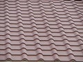 A tiled roof of a building with a wire loop on it Royalty Free Stock Photo