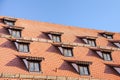 Tiled roof with mansard windows of attic rooms Royalty Free Stock Photo