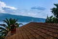 Tiled roof of an old house overlooking the sea and mountains Royalty Free Stock Photo