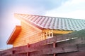 The tiled roof of the village house is illuminated by the sun af Royalty Free Stock Photo