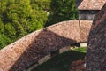 Tiled roof of Viscri fortified church surrounded by lush greenery. Romania