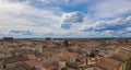 Tiled roofs of houses of the old French city under the cloudy sk Royalty Free Stock Photo