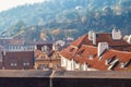 Tiled roofs of old houses in the autumn morning in Prague