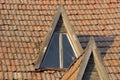 Tiled rooftop of an old house. Abandoned buildings are in need of renovation. Roof texture with shingles Royalty Free Stock Photo