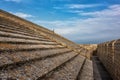 Tiled slanted roof of the fortified church Notre-Dame-de-la-Mer with blue cloudy sky, Saintes-Maries-de-la-Mer, Camargue, France Royalty Free Stock Photo