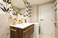 Tiled toilet with large cream tiles, gold faucet, Egyptian cotton