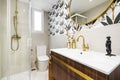 Tiled toilet with large cream tiles, gold faucets, Egyptian cotton