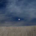 Tiled top of the roof and cloudy blue sky Royalty Free Stock Photo