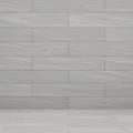 Tiled wall and floor featuring large rectangular tiles in a light gray color with a subtle Royalty Free Stock Photo