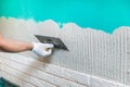 Tiler applying tile adhesive on the wall Royalty Free Stock Photo