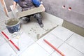 The tiler builder arranges the bathroom ceramics.