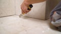 The worker cleans the seams of ceramic tiles. The technology of professional and highly skilled tile work. The tiler Royalty Free Stock Photo