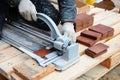 Tiler construction worker cuts tiles Tile. Working with decorative tile cutting equipment at repair renovation work Royalty Free Stock Photo