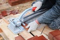 Tiler construction worker cuts tiles Tile. Working with decorative tile cutting equipment at repair renovation work