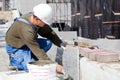 Tiler installing marble tiles