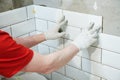 Tiler installing metro tile on wall. home indoors renovation