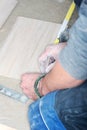 Tiler installs ceramic tiles