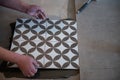 Tiler laying the ceramic tile on the floor. Professional worker makes renovation. Construction. Royalty Free Stock Photo