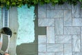 Tiler lays outdoor tiles with the help of a wire for correct positioning