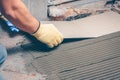 The tiler performs tile installation on the floor Royalty Free Stock Photo
