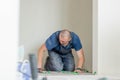 Tiler placing ceramic wall tile in position over adhesive with lash tile leveling system. Ceramic Tiles. Royalty Free Stock Photo