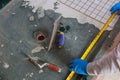 Tiler and plaster repair work laying tile, trowel in a man worker using measuring and marking